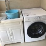 What should I do if I put too much liquid detergent in the washing machine?