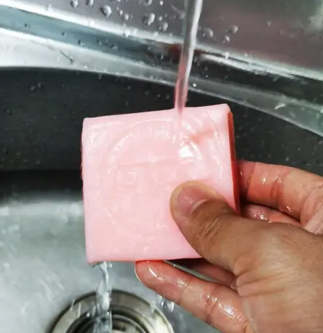 Dampen a new bar of soap with water under the faucet